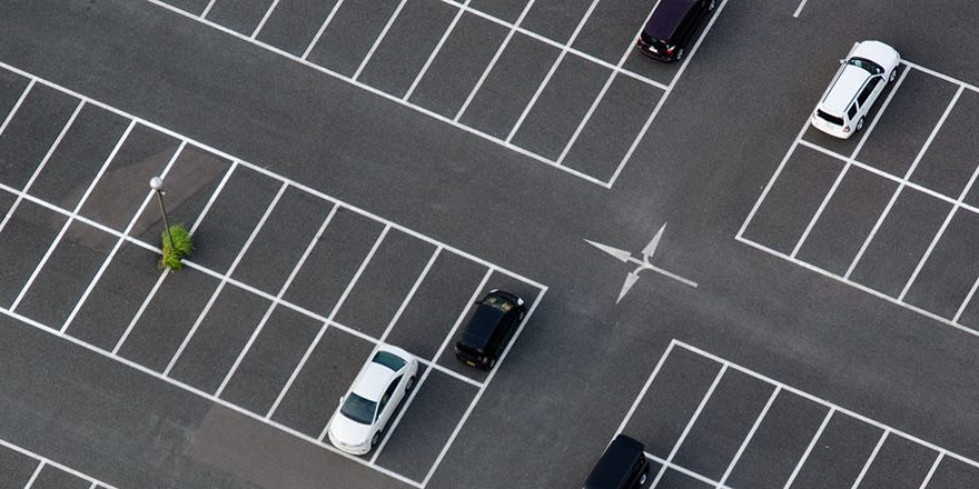 Car park seen from above with many empty parking lots